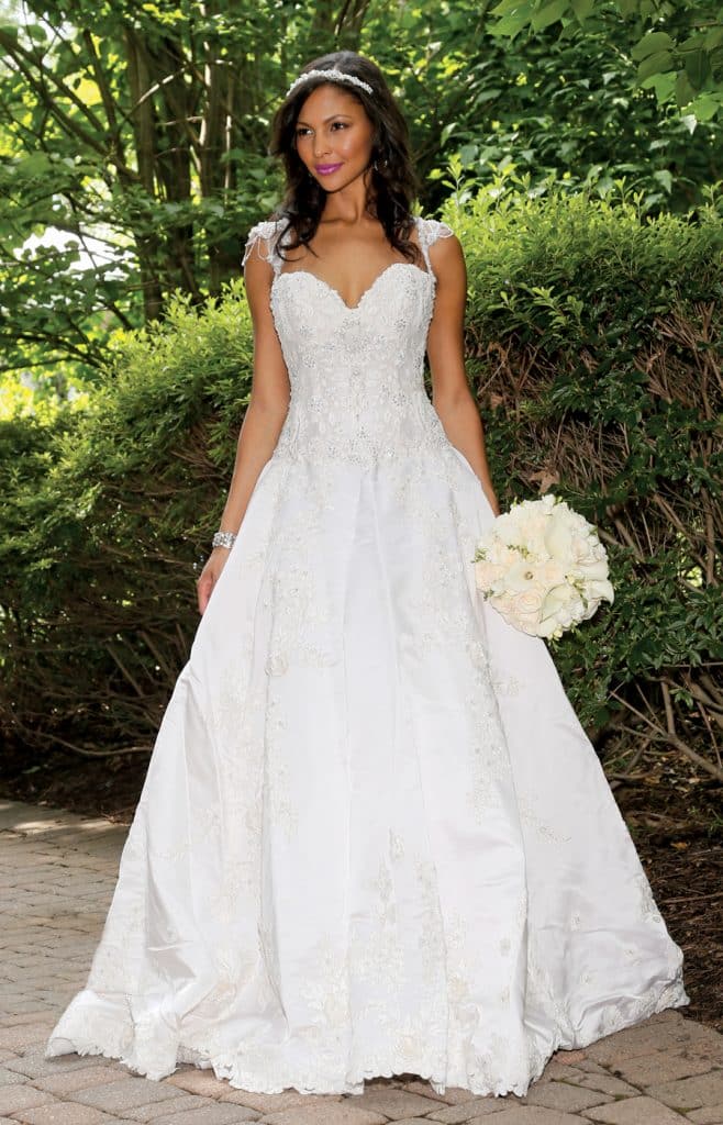Gown: Eve of Milady (335, $6,600). Bouquet: Ariston Flowers