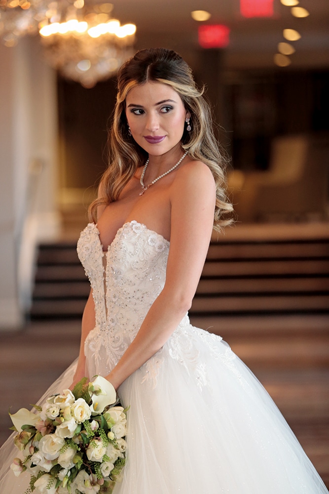 Gown: Eve of Milady (4381). Bouquet: Ariston Flowers.