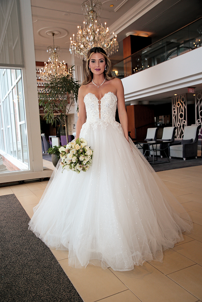 Gown: Eve of Milady (4381). Bouquet: Ariston Flowers.